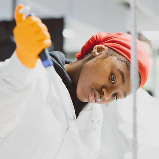 Student using a pippet in a lab