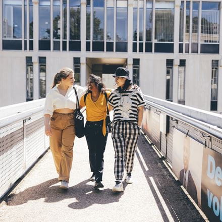 Students walking across the bridge on our Colchester Campus