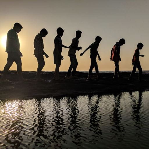 The silhouette of young children of various ages, symbolising childhood, child development and childhood studies.