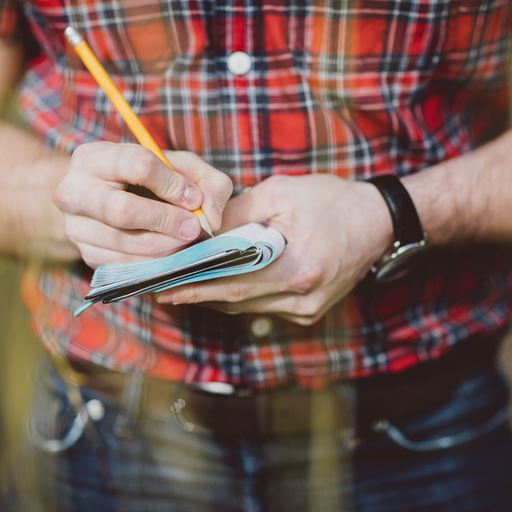 Person scribbling in a notebook