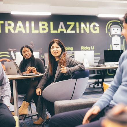 MBA students sit in the Innovation Centre in discussion.
