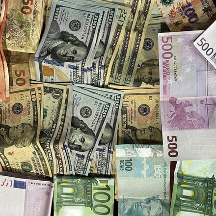 Bank notes of differing currencies, representing the subject of economics and economics degrees.
