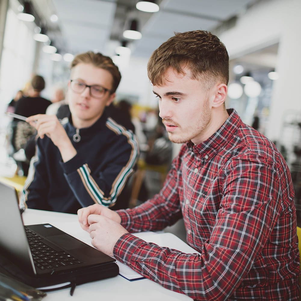 students looking at laptop wanting advice