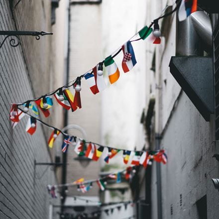 Flags hanging in the street from different nationalities, representing all the languages you can learn at the University of Essex.