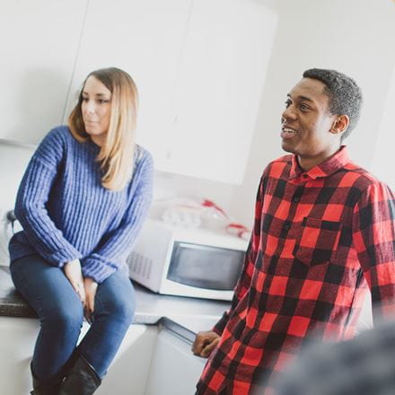 Two students talking in their kitchen 