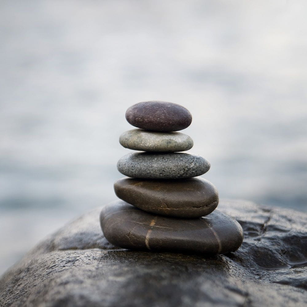 Flat and grey stones balanced on top of each other.
