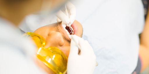 A man having his teeth checked by a dentist