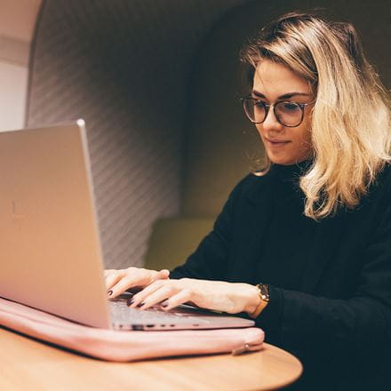 Postgraduate student studying at their computer