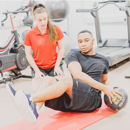 Student showing client exercises in the gym