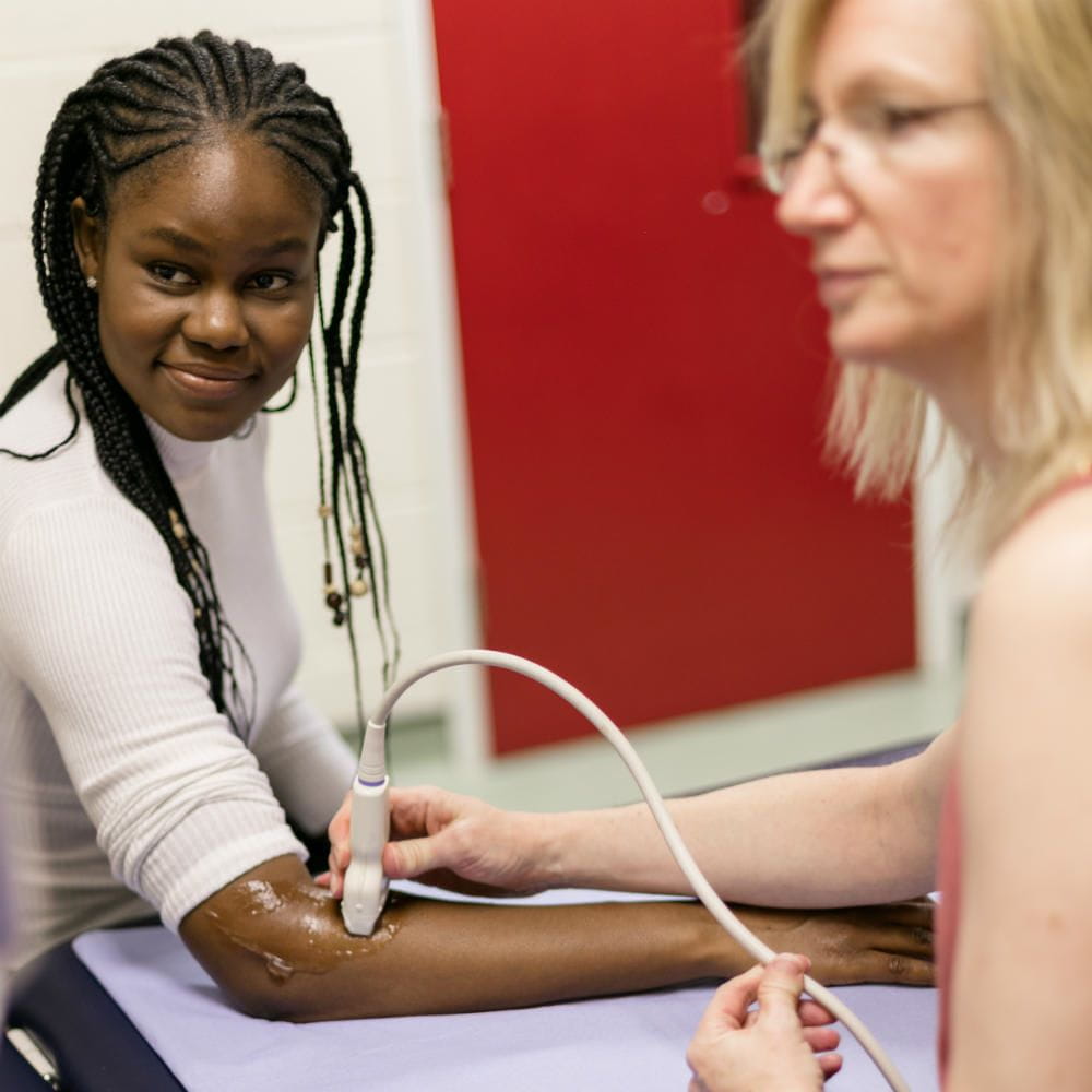 Dr Sue Innes using an ultrasound to check a patients arm.