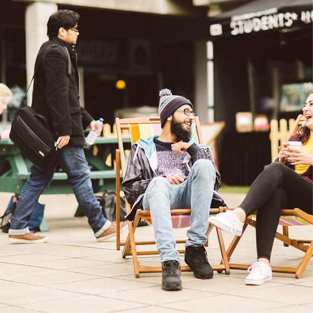 Students sitting in deckchairs on the Squares