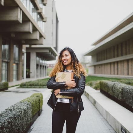 A student walking on campus at the University of Essex.